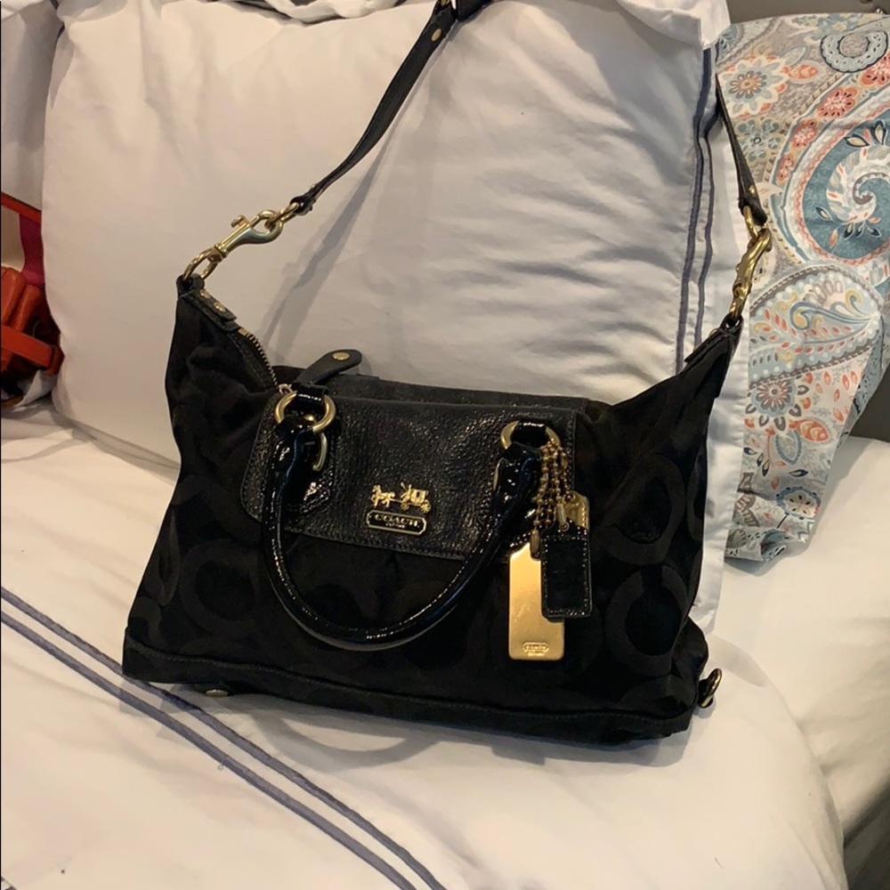 Black coach bag with brass hardware
